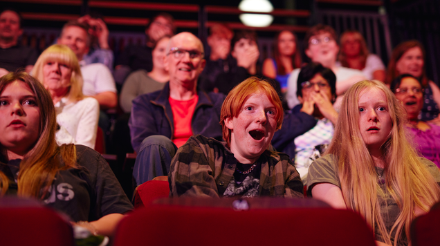 Photograph of Family members enjoying theatre