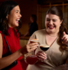 colour photograph of women smiling with cocktails